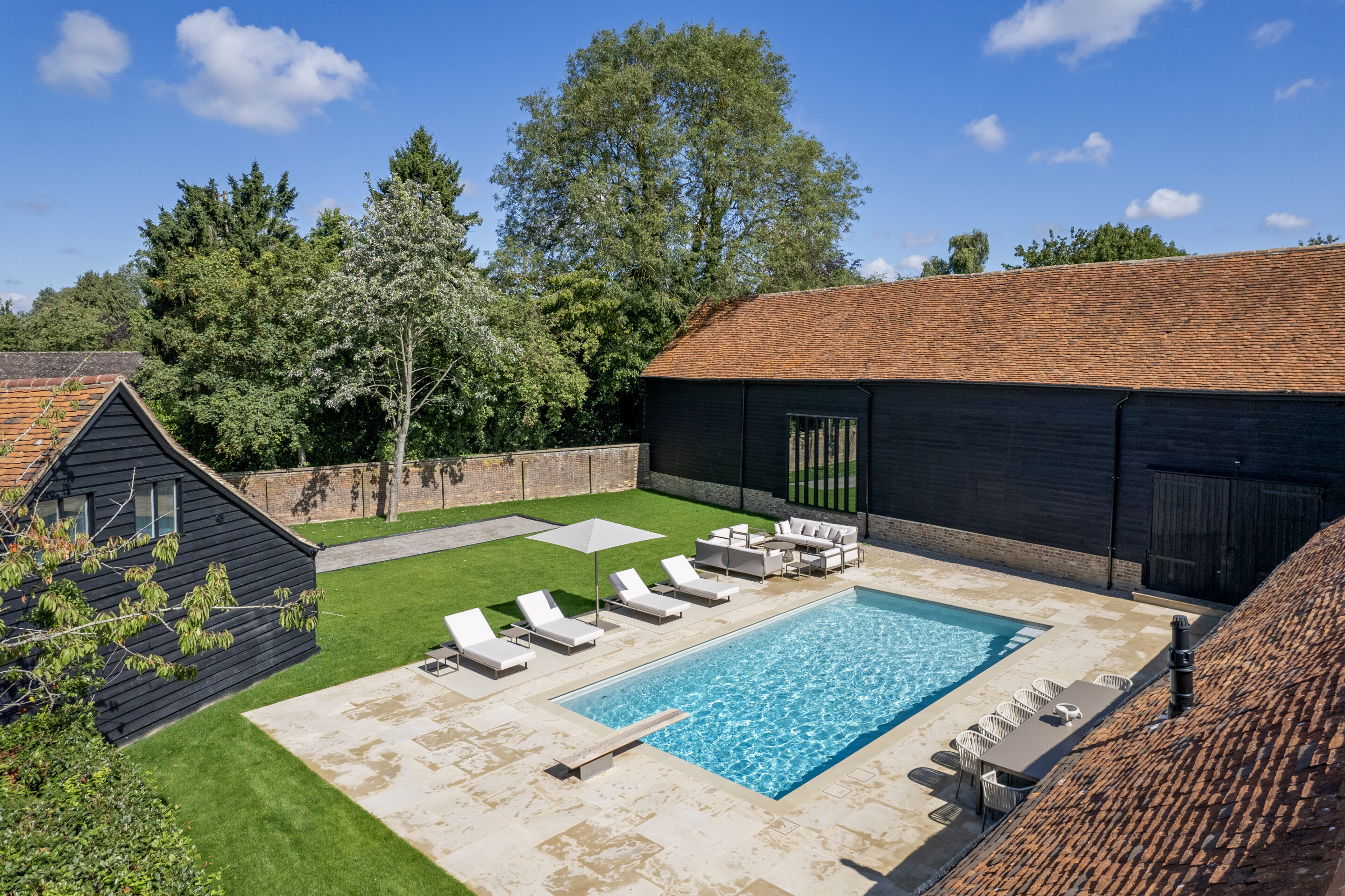 Outdoor swimming pool with diving board, aerial view