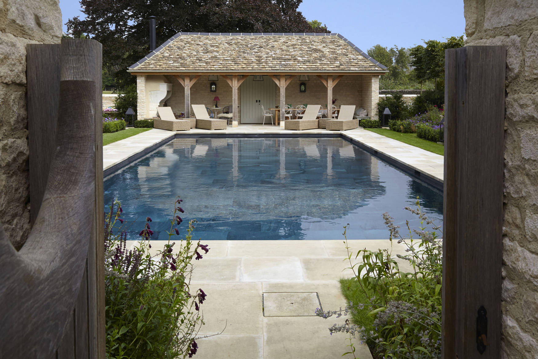 Rustic outdoor kitchen pool nestled in the Oxfordshire countryside
