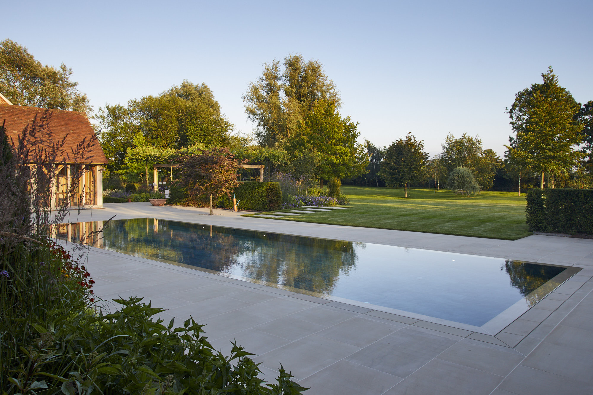 Outdoor swimming pool surrounded by beautiful garden