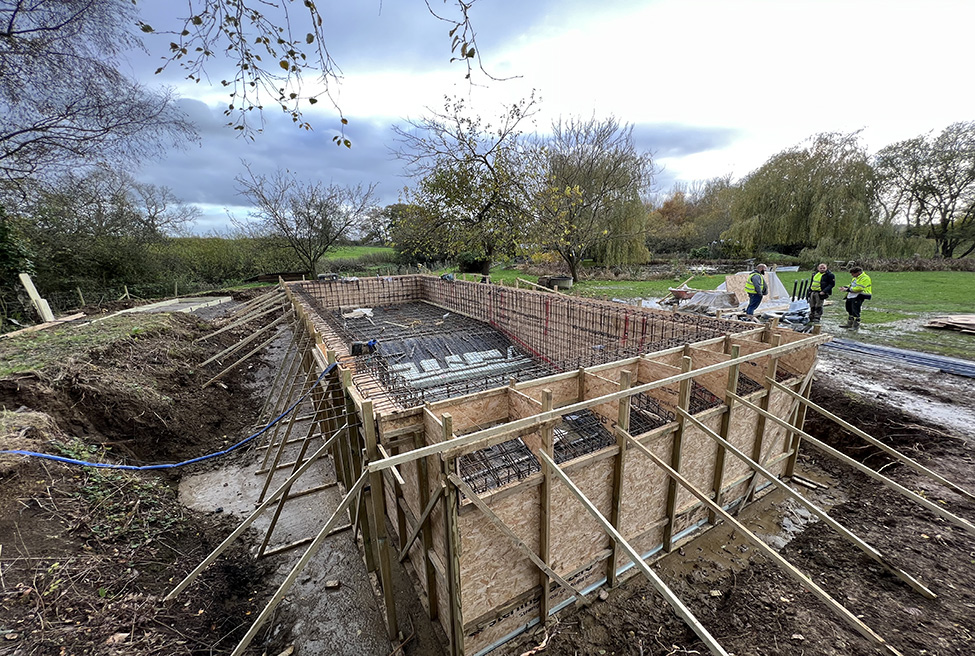 Outdoor swimming pool design and build project in Surrey, completed earlier this year. Boutique hotel inspired appearance, incorporating a glass infinity look and a fantastic teal glass tile colour to complement the garden design.